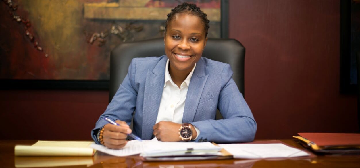 LaToya Jarrett smiling while writing on paper